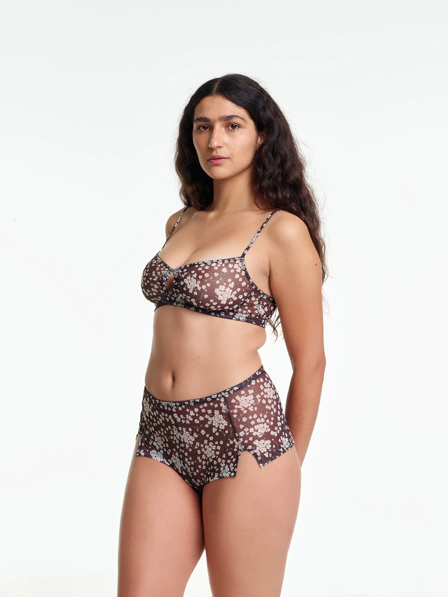 Woman wearing a floral lingerie set on a white background