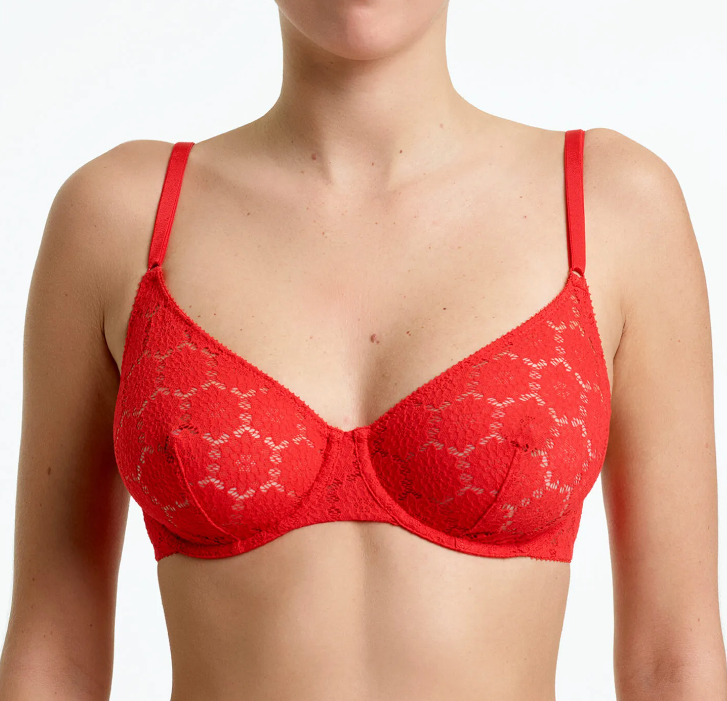 A red lace underwire bra with thin shoulder straps, shown on a model against a plain white background.