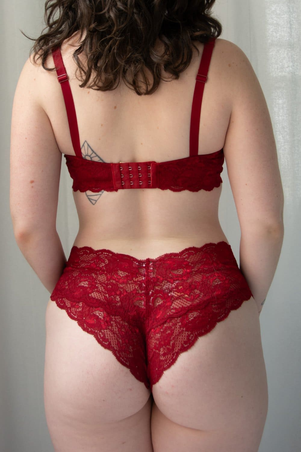 Red lace lingerie set on a plain background