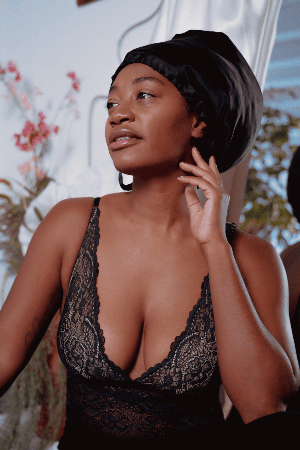 Samantha chang all lace bodysuit in black, front view on a model, close-up.