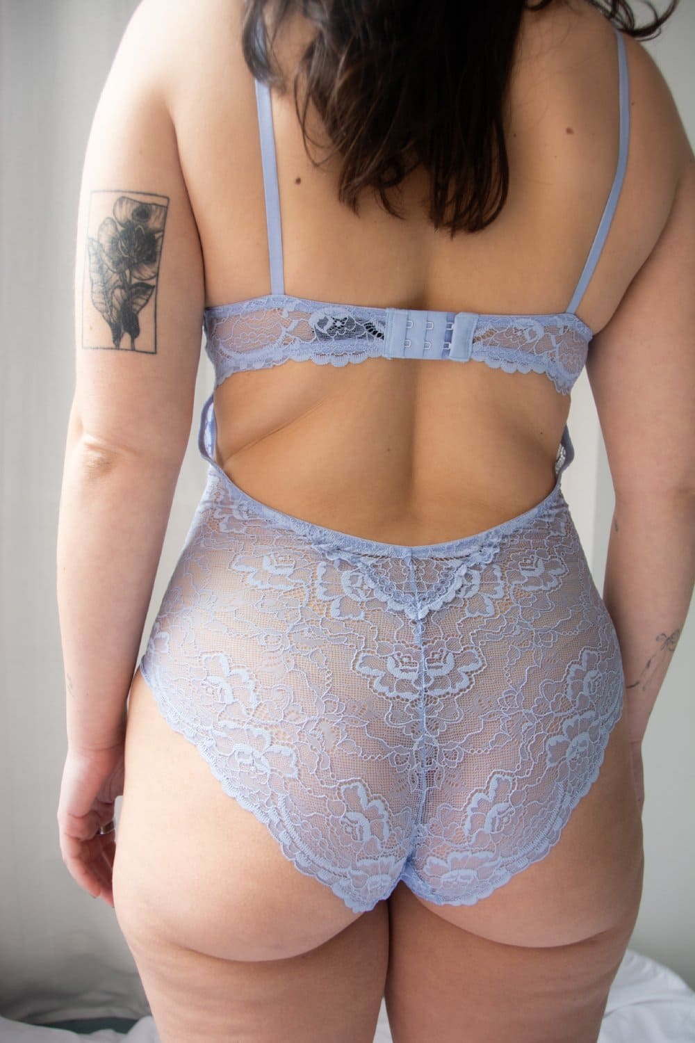 Samantha chang all lace bodysuit in serenity blue, back view on a model, close-up.