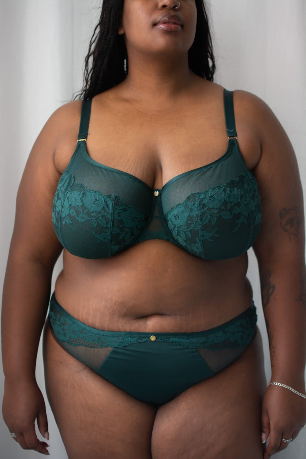 Sculptresse josephine high leg brief in forest green, front view on a model, close-up.