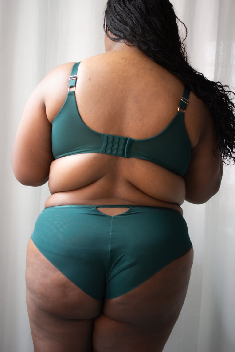 Sculptresse josephine high leg brief in forest green, back view on a model, close-up.