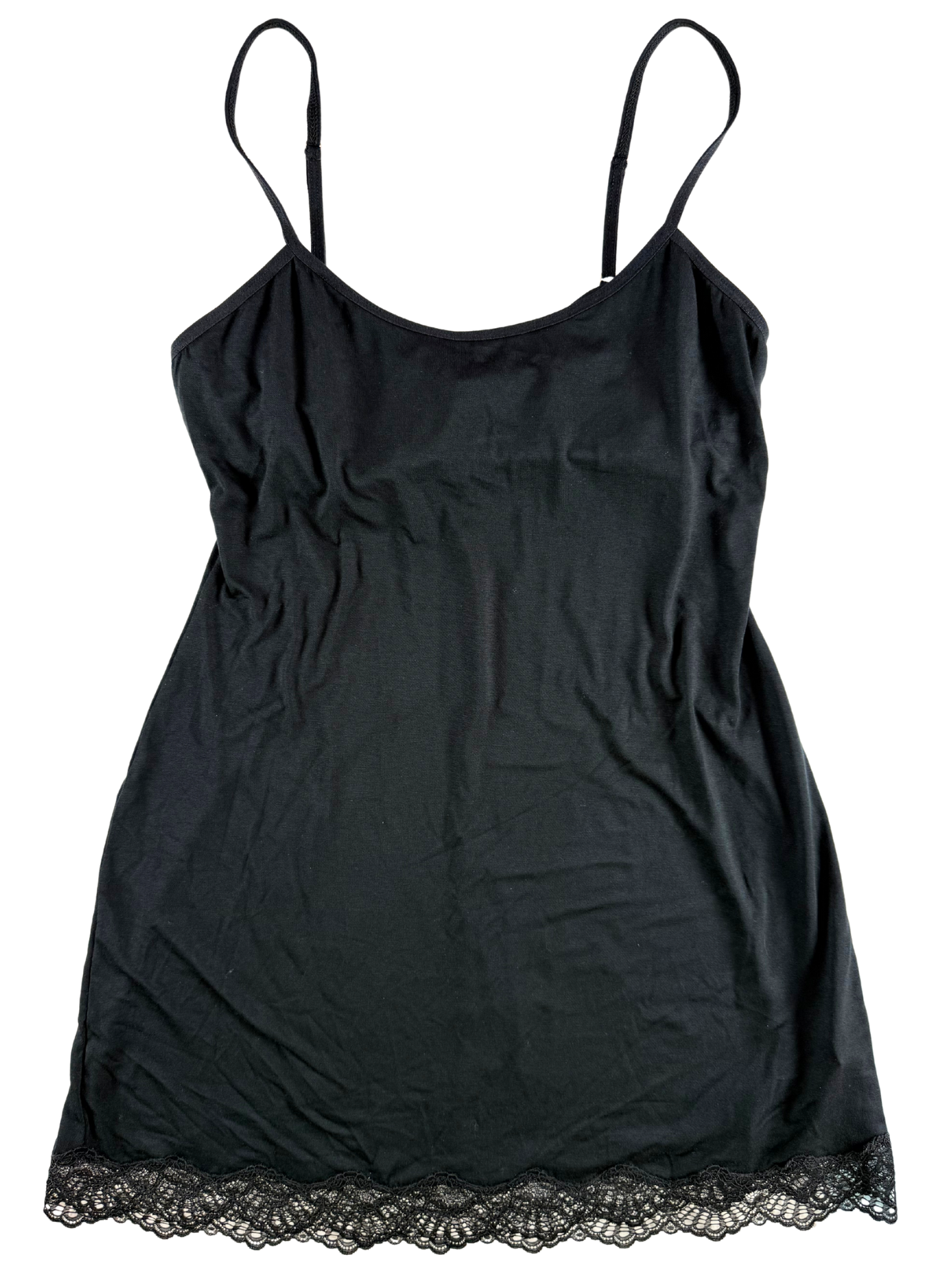 Black slip dress with lace hem on a white background