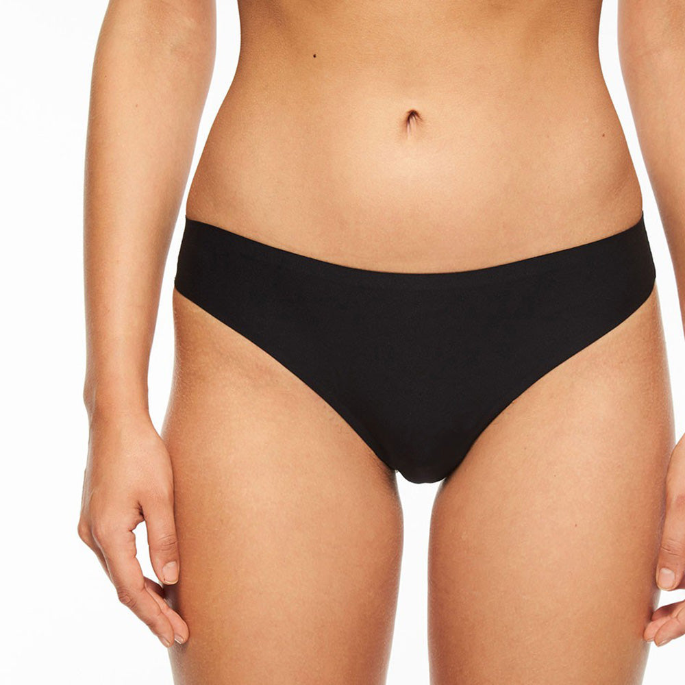 Person wearing black underwear against a white background
