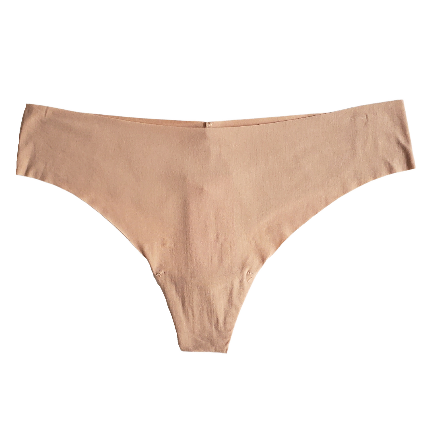 A beige Commando brand seamless thong underwear laid flat on a surface.